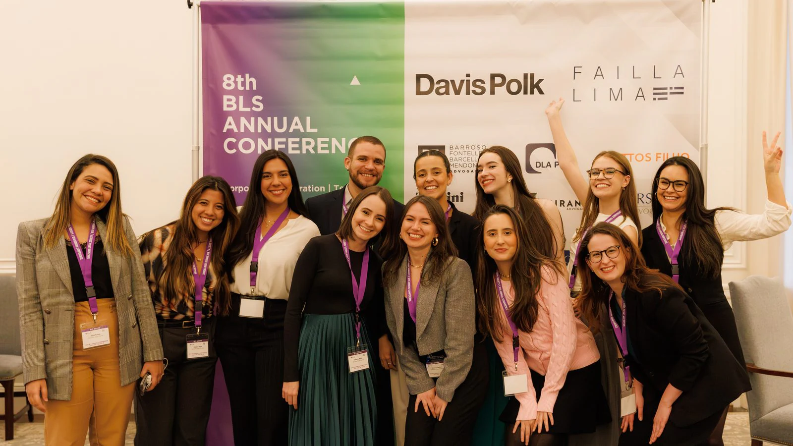 8th BLS Annual Conference: BLS members together in front of the conference backdrop