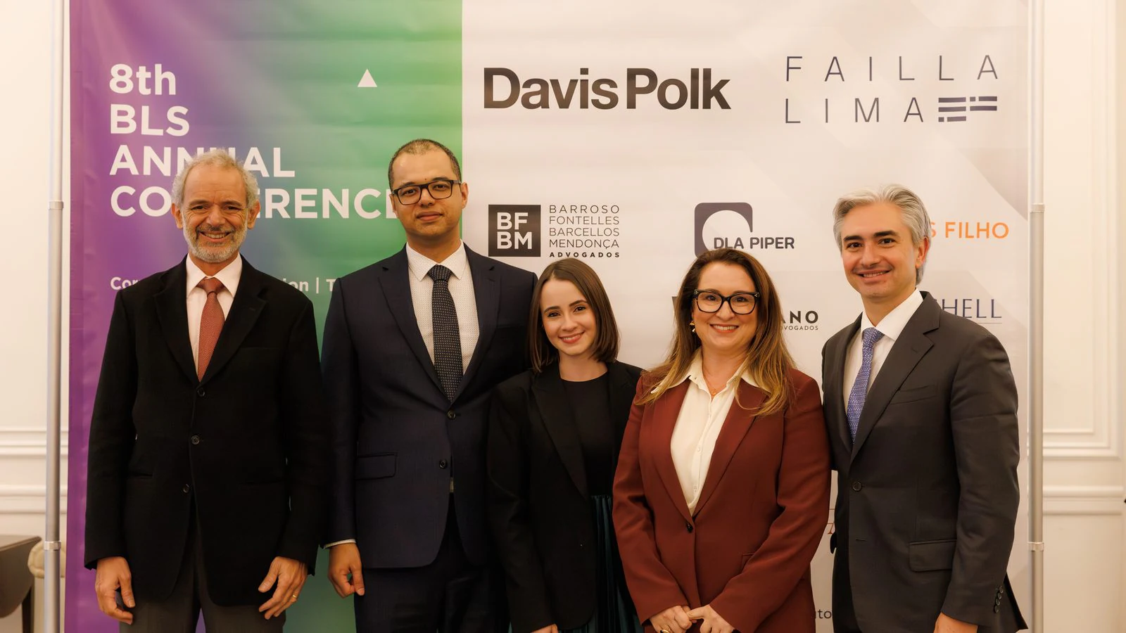 8th BLS Annual Conference: Speakers in front of the conference backdrop