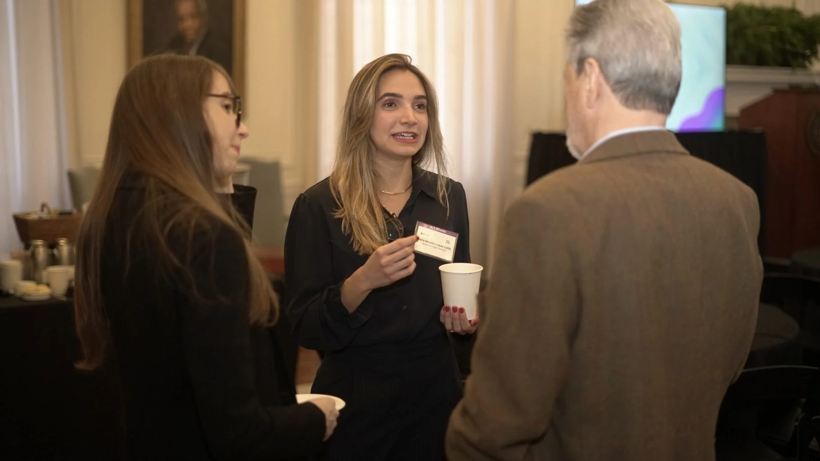 Guests talking during a break, 9th conference